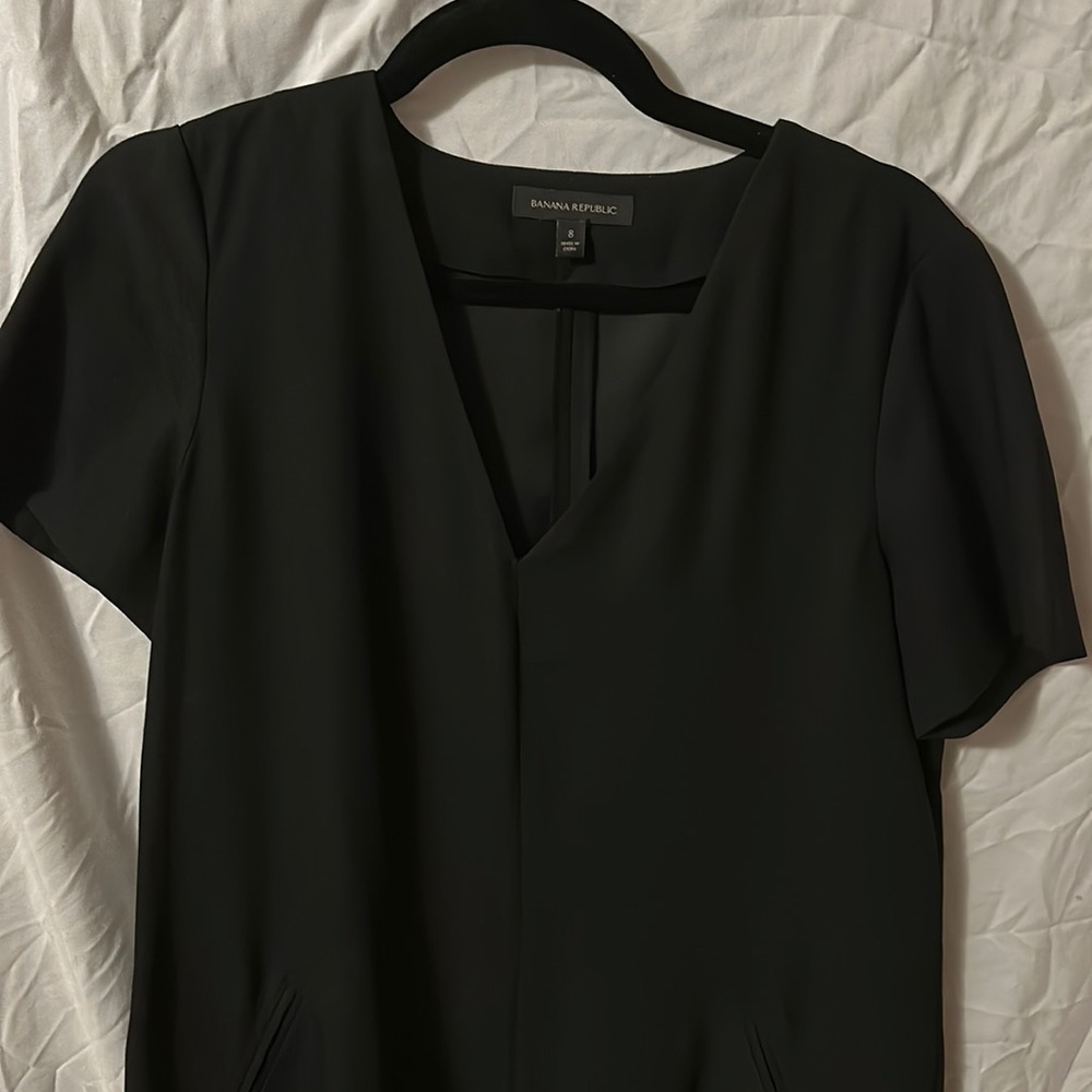 Banana Republic size 8. Black short sleeve dress with shirt-tail hem.